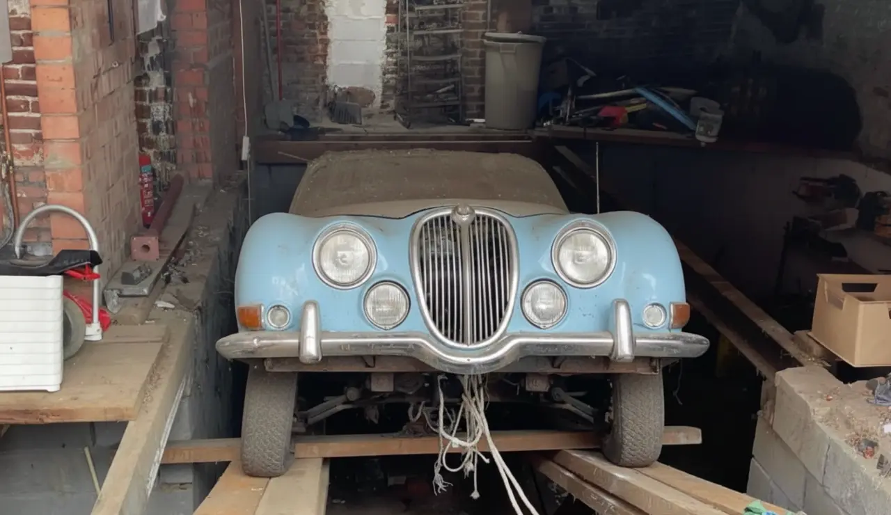 Antique Dealer Discovers 1964 Jaguar Under Garage Floor While Clearing Out House in Kessel-Lo